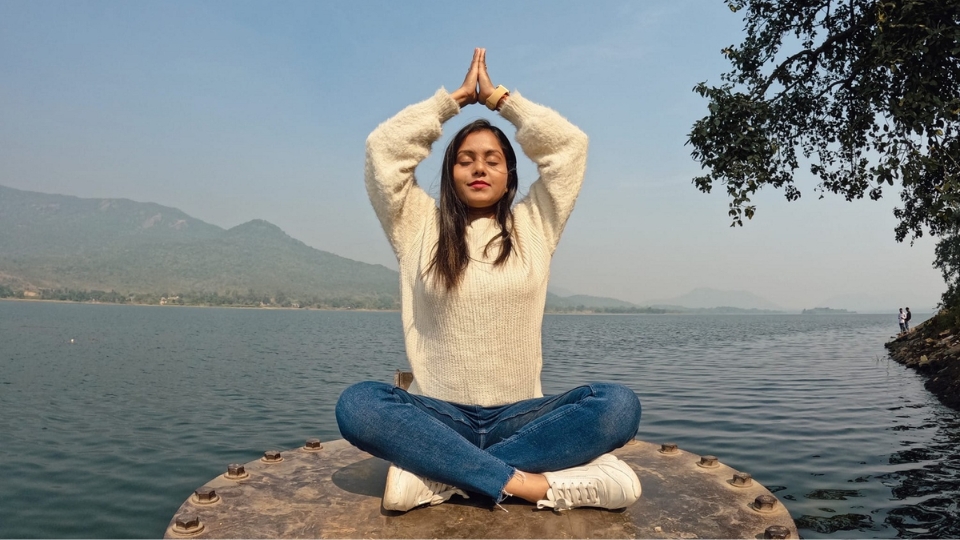 A person meditating in a quiet studio.